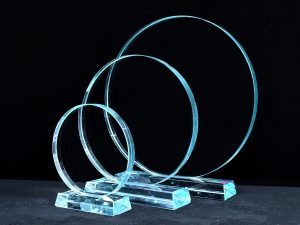 A series of three circular glass awards with rectangle bases from Awards By Hammond